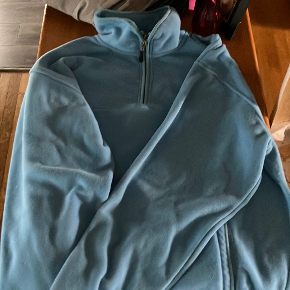 A blue sweatshirt been wore once at most